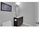 Modern powder room featuring gray walls, a vanity with storage, and stylish decor for guests at 1919 Belcastro St, Las Vegas, NV 89117