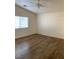 Bedroom boasts wood floors, a ceiling fan, neutral walls and a bright window at 2050 N Los Feliz St # 114, Las Vegas, NV 89156