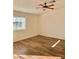 Bright bedroom featuring hardwood floors, a ceiling fan, and a large window offering plenty of natural light at 2050 N Los Feliz St # 114, Las Vegas, NV 89156
