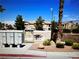 Exterior shot of a charming community mailbox and picnic area, landscaped with rocks, trees, and shrubs at 2050 N Los Feliz St # 114, Las Vegas, NV 89156