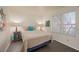 Inviting bedroom featuring wood-look floors, art, and a cozy bed near the window at 2068 Mesquite Ln # 203, Laughlin, NV 89029