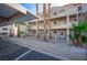 Condominium building with exterior walkways, mature palm trees, and desert landscaping at 2068 Mesquite Ln # 203, Laughlin, NV 89029