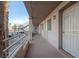 Exterior hallway with white doors and railings, palm trees, and exterior metal staircase at 2068 Mesquite Ln # 203, Laughlin, NV 89029