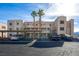 Condominium building with covered parking featuring desert landscaping on a sunny day at 2068 Mesquite Ln # 203, Laughlin, NV 89029