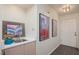 Hallway featuring a sink and cabinet, art, a neutral-toned door, and laminate flooring at 2068 Mesquite Ln # 203, Laughlin, NV 89029