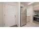 Bright kitchen featuring stainless steel refrigerator, white cabinets and countertops and tile flooring at 2068 Mesquite Ln # 203, Laughlin, NV 89029
