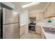 Bright kitchen featuring stainless steel refrigerator, stainless steel stove and white cabinets and countertops at 2068 Mesquite Ln # 203, Laughlin, NV 89029