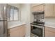 Bright kitchen featuring stainless steel stove, bright window and light wood cabinets and countertops at 2068 Mesquite Ln # 203, Laughlin, NV 89029