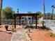 Community pergola with seating for picnics, desert landscaping, and palm trees for shade at 2068 Mesquite Ln # 203, Laughlin, NV 89029