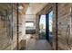 Modern bathroom with dual shower heads, neutral tile, and a large window overlooking the desert landscape at 21 Rockstream Dr, Henderson, NV 89012