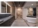 Sleek bathroom with double vanity, modern soaking tub, and natural stone accents at 21 Rockstream Dr, Henderson, NV 89012