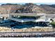Striking modern home with a cantilevered design and large windows nestled against a rocky hillside at 21 Rockstream Dr, Henderson, NV 89012