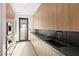 Modern kitchen with sleek cabinets, black countertops, and stainless steel appliances at 21 Rockstream Dr, Henderson, NV 89012