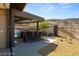 Outdoor kitchen area with stainless steel grill and bar seating with desert view at 21 Rockstream Dr, Henderson, NV 89012