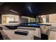 Luxury pool area featuring a dark bottom pool, adjacent patio with desert landscaping and fire pit at 21 Rockstream Dr, Henderson, NV 89012