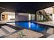 Luxurious dark bottom pool view with desert landscaping and home's architectural design at 21 Rockstream Dr, Henderson, NV 89012