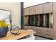 Custom wine storage solution featuring glass doors, wood finishes, and elegant display lighting at 21 Rockstream Dr, Henderson, NV 89012