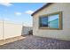 Backyard patio with brick pavers, fencing, and an exterior view of the home at 2175 Limestone Cove Ct, Laughlin, NV 89029