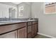 Bathroom featuring a double sink vanity with dark wood cabinets and granite countertops at 2175 Limestone Cove Ct, Laughlin, NV 89029
