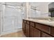 Bathroom featuring a glass-enclosed shower and double sink vanity with granite countertop at 2175 Limestone Cove Ct, Laughlin, NV 89029