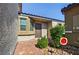 Inviting front entrance with a brick walkway, a neutral-toned exterior, and charming desert landscaping at 2175 Limestone Cove Ct, Laughlin, NV 89029