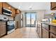 Bright kitchen featuring stainless steel appliances, granite countertops, and access to the patio at 2175 Limestone Cove Ct, Laughlin, NV 89029