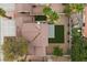 Aerial view showcases home's roof, backyard desert landscaping and mature palm trees at 2344 Valleywood St, Henderson, NV 89014