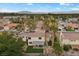 Neighborhood aerial view showcases residential homes, backyard patios, desert landscaping and mature palm trees at 2344 Valleywood St, Henderson, NV 89014