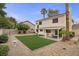 Wide backyard featuring a covered patio, low-maintenance landscaping, and artificial turf at 2344 Valleywood St, Henderson, NV 89014
