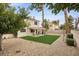 Spacious backyard with low-maintenance landscaping, artificial turf, and covered patio at 2344 Valleywood St, Henderson, NV 89014