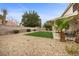 Backyard area with low-maintenance landscaping, artificial turf, covered patio and privacy wall at 2344 Valleywood St, Henderson, NV 89014