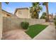Narrow backyard area with a brick wall, low-maintenance landscaping, and small artificial turf area at 2344 Valleywood St, Henderson, NV 89014