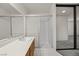 Bright bathroom featuring a shower with sliding glass door, sink and ample counter space at 2344 Valleywood St, Henderson, NV 89014