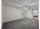 Large bedroom with gray carpeting, ceiling fan, and views of the ensuite bath at 2344 Valleywood St, Henderson, NV 89014