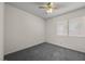 Bedroom with neutral colored carpet, ceiling fan, window and paint at 2344 Valleywood St, Henderson, NV 89014