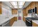 Bright kitchen with tile countertops, a microwave, and wood cabinets at 2344 Valleywood St, Henderson, NV 89014