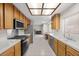 Galley kitchen with stainless steel appliances and a bright tile floor at 2344 Valleywood St, Henderson, NV 89014