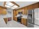 Kitchen with stainless appliances, wood cabinets, and tile countertops at 2344 Valleywood St, Henderson, NV 89014