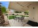 Covered patio with outdoor dining, low-maintenance landscaping, and privacy wall in the backyard at 2344 Valleywood St, Henderson, NV 89014