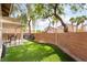 Great backyard featuring artificial grass, a privacy wall, and covered patio at 2354 Buffalo Run Ave, Las Vegas, NV 89123