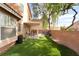 Spacious backyard featuring artificial grass and covered patio area at 2354 Buffalo Run Ave, Las Vegas, NV 89123