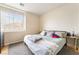 Comfortable bedroom with a light green bedspread, plush pillows, and ample natural light from window at 2354 Buffalo Run Ave, Las Vegas, NV 89123