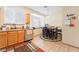 Bright kitchen with stainless steel appliances, light wood cabinets, and dining area near window at 2354 Buffalo Run Ave, Las Vegas, NV 89123