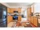 Spacious kitchen featuring wooden cabinets, granite countertops, and modern stainless steel appliances at 2354 Buffalo Run Ave, Las Vegas, NV 89123