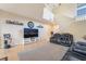 Inviting living room featuring modern sofas, a media center, and a staircase to the upper level at 2354 Buffalo Run Ave, Las Vegas, NV 89123
