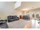 Spacious living room with a modern sofa set, dining area, and access to the backyard at 2354 Buffalo Run Ave, Las Vegas, NV 89123