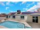 View of backyard featuring a pool, solar panels and tile roof at 2860 Misty Ct, Henderson, NV 89074