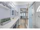 Bathroom featuring an extra long white countertop, an artistic mirror, and a glass shower at 2860 Misty Ct, Henderson, NV 89074