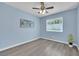 Cozy bedroom with sleek flooring, ceiling fan, and natural light from the window at 2860 Misty Ct, Henderson, NV 89074