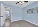 Bedroom with ensuite bathroom, sleek floors, blue walls, ceiling fan, and art at 2860 Misty Ct, Henderson, NV 89074